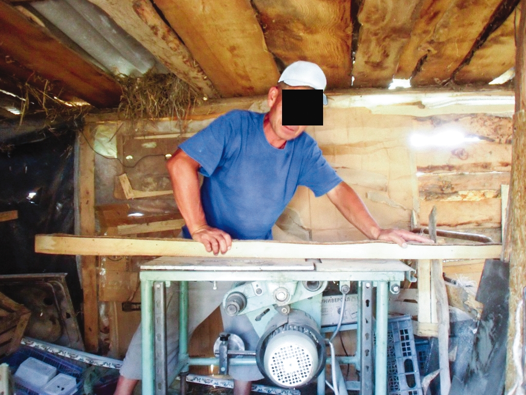 a man at work cutting wood 