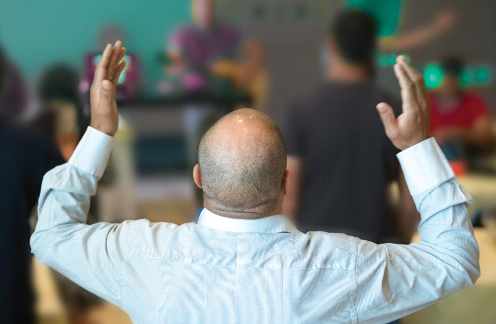 Man raising his hands in worship service