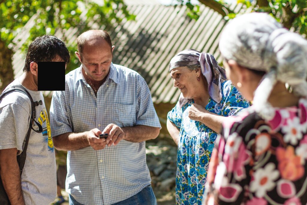 a group of people stand together talking 